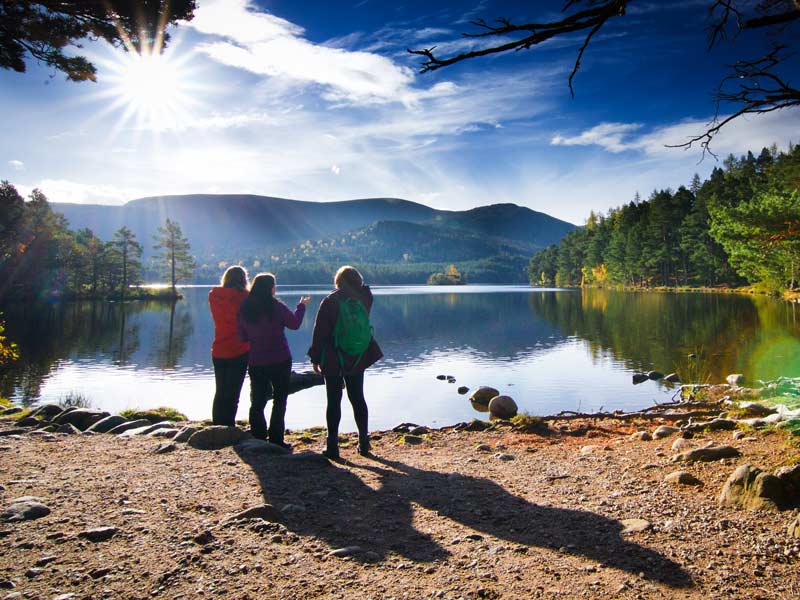 Three hikers on the edge of Loch an Eilein